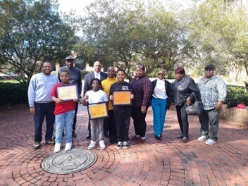 Group of children and adults in front of box office for a field trip.