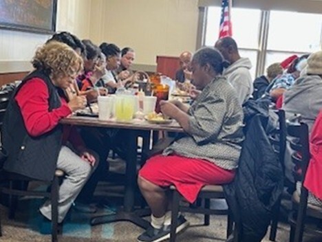People sitting at a table eating.