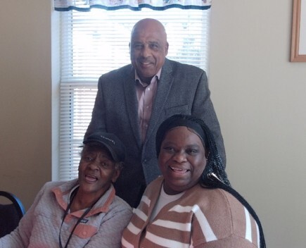Three people smiling for a picture.