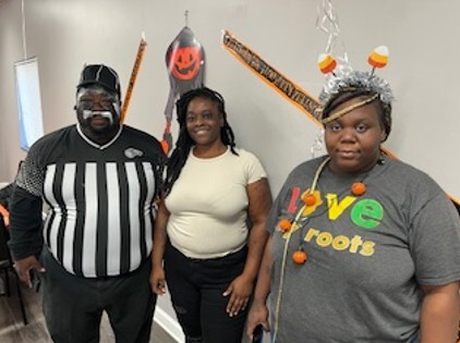Three people in Halloween outfits.