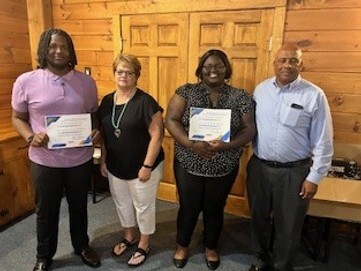 Carolina's Council recipient Ky'Naisha Bobbit smiles with three other people for a picture.