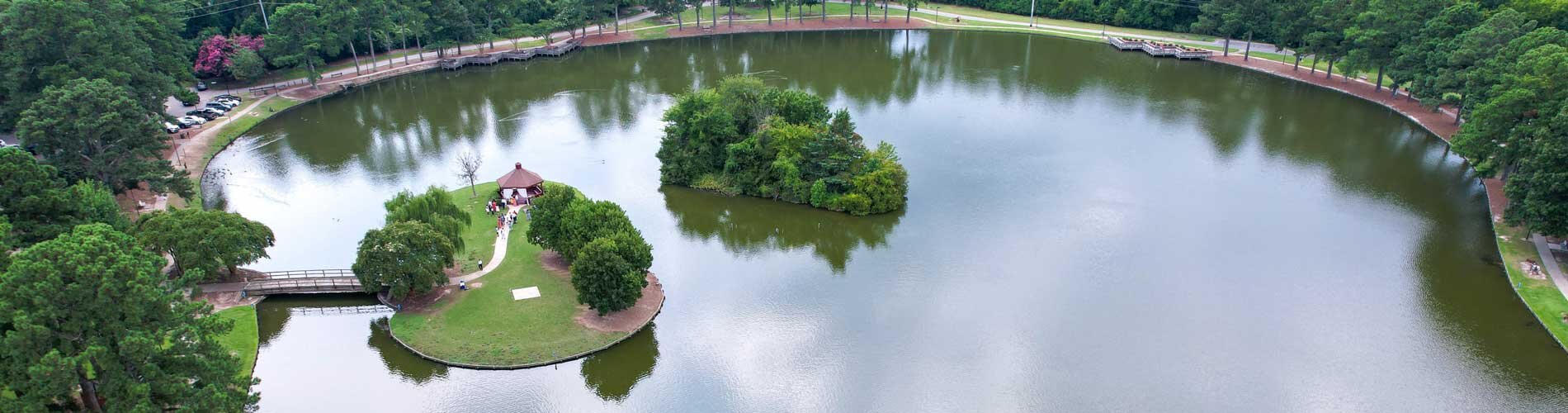 Aerial view of lake with island pavilion.